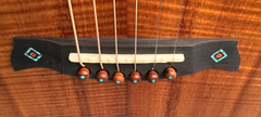 Osthoff OM Krazy Koa guitar bridge with inlays